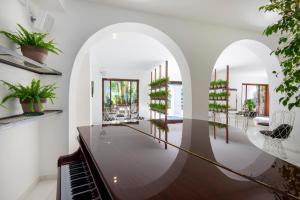 a living room with a piano and plants at Hotel Villa Durrueli Resort & Spa in Ischia