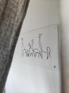 a drawing of a group of giraffes on a wall at Giraffe Studio @ Kruger in Marloth Park