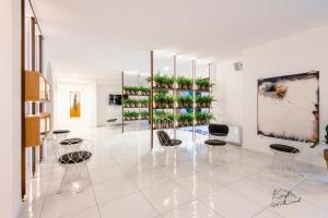a room with chairs and plants on a wall at Hotel Villa Durrueli Resort & Spa in Ischia