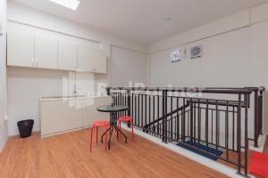 a kitchen with a table and two stools in a room at 158 Guest House Syariah RedPartner in Bandung