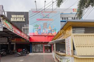 a building with a large billboard on the side of it at 158 Guest House Syariah RedPartner in Bandung