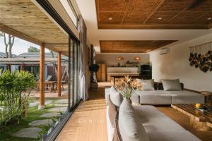 a living room with a couch and a table at LaMon House - Venuestay in Hòa Bình