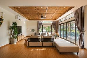 a living room with a couch and a table at LaMon House - Venuestay in Hòa Bình +60 photos