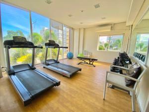 a gym with several treadmills and chairs and windows at 2BR within the heart of the City with WIFI and Netflix in Davao City