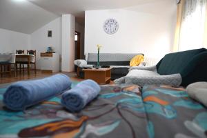 a living room with a couch with blue pillows on it at Apartman Sena in Laktaši