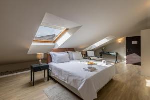 a bedroom with a large white bed and a window at Leonis Restaurant & Rooms in Split