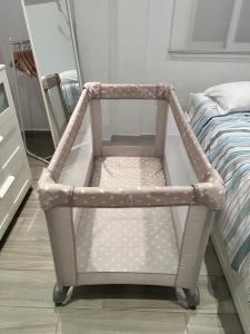 a baby cart sitting next to a bed at Beach apartment LA CALA DE MIJAS in La Cala de Mijas