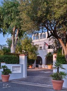a white building with trees in front of it at Hotel Villa Durrueli Resort & Spa in Ischia