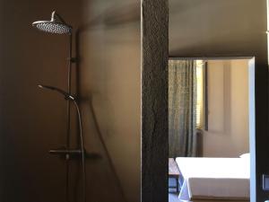 a bathroom with a shower with a bed and a lamp at Palazzo del Settecento in Ravenna