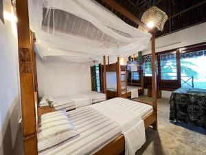 Postel nebo postele na pokoji v ubytování Lui Ushongo Beach House