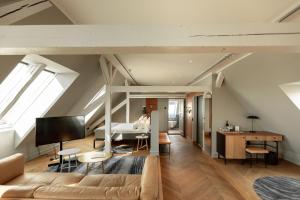 a loft conversion with a living room and a bedroom at Nobis Hotel Copenhagen, a Member of Design Hotels™ in Copenhagen