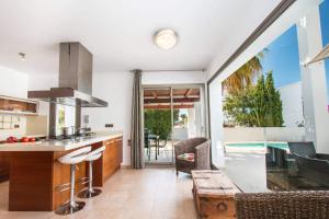 a kitchen and living room with a view of a pool at Villa Athos - PlusHolidays in Calpe