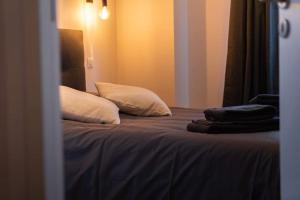 a bedroom with a bed with pillows on it at La Ferme de Bacchus in Hautvillers +2 photos
