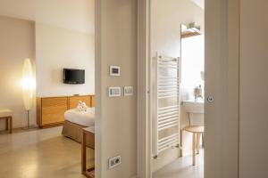 a hotel room with a bed and a bathroom at The Ziba Hotel & Spa in Peschiera del Garda