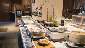a buffet line with many different dishes and food at Lotte Arai Resort in Myoko