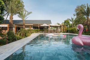 a swimming pool with a pink flamingo in a house at LaMon House - Venuestay in Hòa Bình