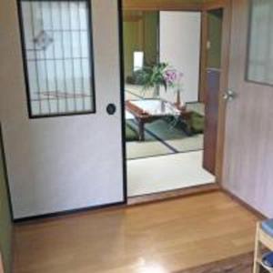 a door leading to a living room with a porch at Nikko PRIVATE INN WA NODOKA in Nikko