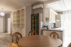 a kitchen with a wooden table and chairs in a room at Youhosty - Napoli 35 in Milan