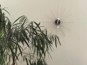 a windmill on a wall next to a plant at Villa Yvonne - Superbe vue Deco chic Confort et Climatisation in Marseille