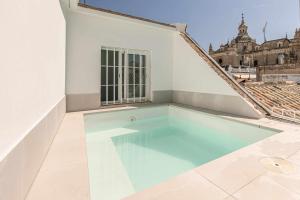 a swimming pool in the middle of a building at ISG Apartments Cuna in Seville