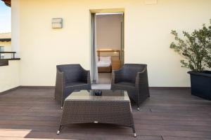 two chairs and a table on a patio at The Ziba Hotel & Spa in Peschiera del Garda