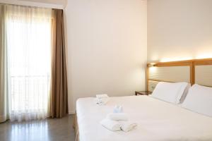a hotel room with a bed with towels on it at The Ziba Hotel & Spa in Peschiera del Garda