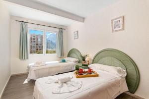 um quarto de hotel com duas camas e uma janela em Apartamento Arenal 6 - PlusHolidays em Calpe