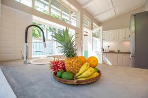 a bowl of fruit on a counter in a kitchen at La Garçonniere in Saint-Pierre