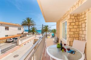 a balcony with a table and a view of the ocean at Apartamento Arenal 4 - PlusHolidays in Calpe