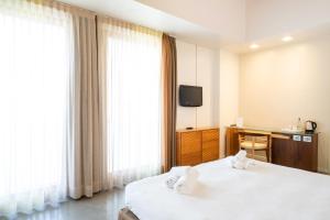 a hotel room with two beds and a television at The Ziba Hotel & Spa in Peschiera del Garda