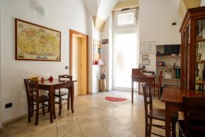 a dining room with tables and chairs and a map on the wall at La Bella Lecce B&B in Lecce