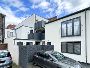 a car parked in front of a white house at Smart Living by Lawsons in Windsor