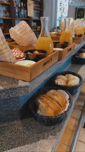 a counter with some bread and bottles of orange juice at De Lanterfanters B&B 2.0 in Ramskapelle +4 photos