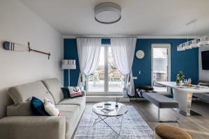 a living room with a couch and a table at Balatonic Sky in Zamárdi