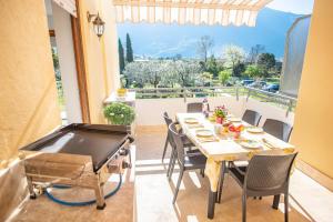 a dining room with a ping pong table and a balcony at Arcolovers in Arco