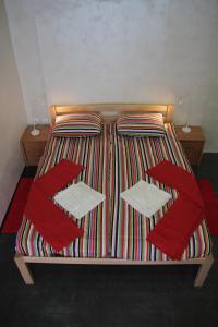 a bed with a blanket and pillows on it at Guest House Miss Depolo in Belgrade