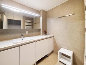 a bathroom with a sink and a mirror at Hotel Restaurant Steenhuyse in Oudenaarde