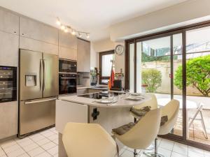 a kitchen with a table and chairs and a large window at Appartement Biarritz, 2 pièces, 4 personnes - FR-1-3-530 in Biarritz