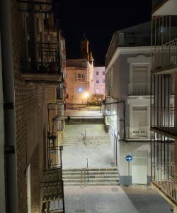 an alley with stairs and buildings at night at Green Apartamentos Cartagena in Cartagena