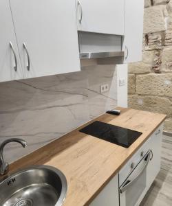 a kitchen with white cabinets and a sink at Green Apartamentos Cartagena in Cartagena