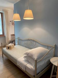 a bedroom with a bed with two lights above it at B&B Antico Fienile in Gorizia