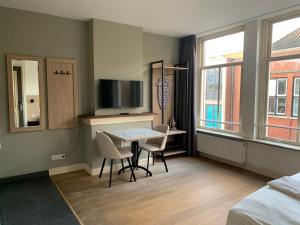 Et tv og/eller underholdning på Plantage Hortus Apartments