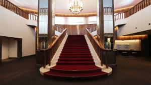 a staircase in a building with a red carpet at Lotte Arai Resort in Myoko +209 photos