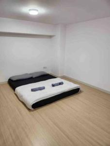 a bed in a room with two pillows on it at Sunway Grid by One Team in Kampong Pendas