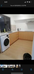 a kitchen with a sink and a washing machine at Sunway Grid by One Team in Kampong Pendas