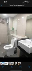 a bathroom with a white toilet and a sink at Sunway Grid by One Team in Kampong Pendas