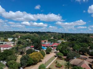 an aerial view of a small town with houses and trees at Neat one bedroom in Morningside guesthouse - 2089 in Bulawayo