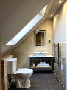 a bathroom with a toilet and a sink at The Three Pickerels in Mepal