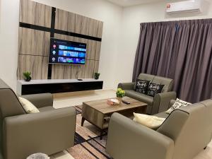 un soggiorno con divani e TV a schermo piatto di Casa Le View a Kuah