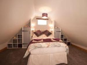 a bedroom with a bed in a attic at Little Rigg Cottage in Pickering